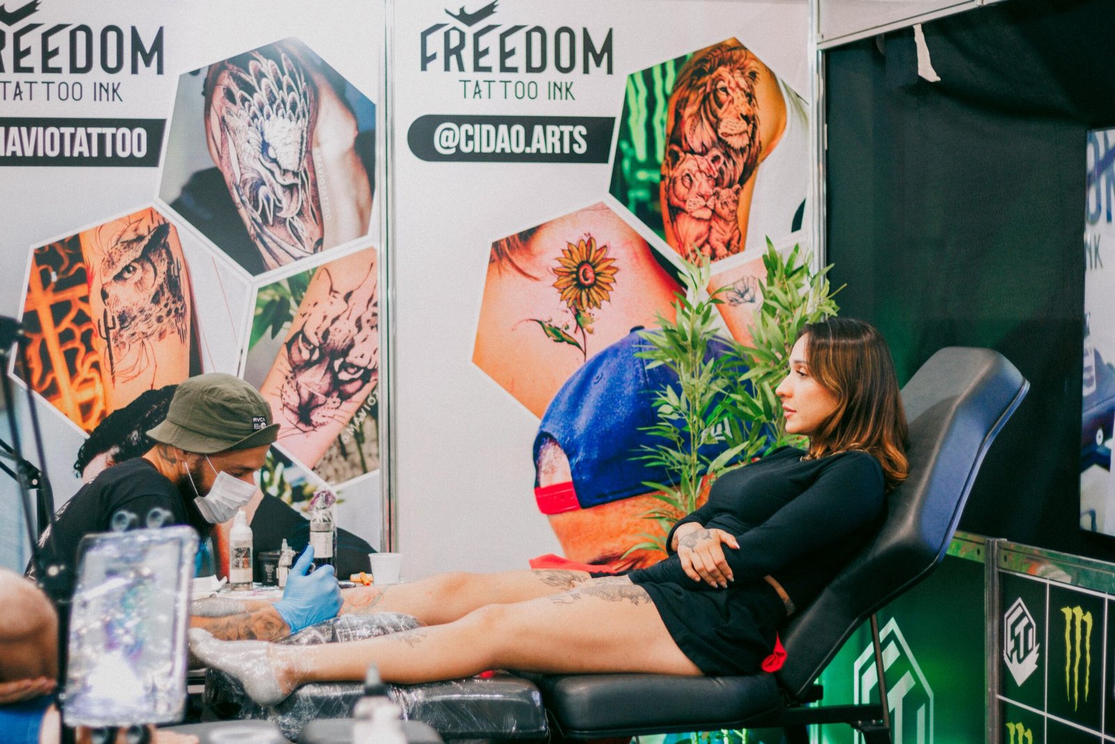 Tattoo artist creating detailed art in a vibrant studio setting.